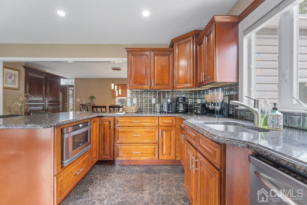 713 New Dover Road Edison, NJ 08820 - Photo 18 of 46 a kitchen with stainless steel appliances granite countertop a sink a stove and a refrigerator