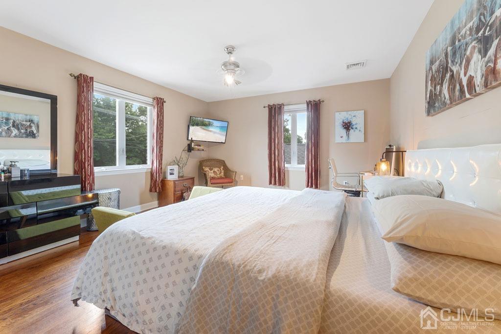 713 New Dover Road Edison, NJ 08820 - Photo 19 of 46 a spacious bedroom with a bed and wooden floor