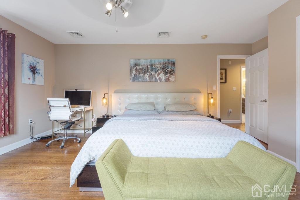 713 New Dover Road Edison, NJ 08820 - Photo 20 of 46 a bedroom with a bed and wooden floor
