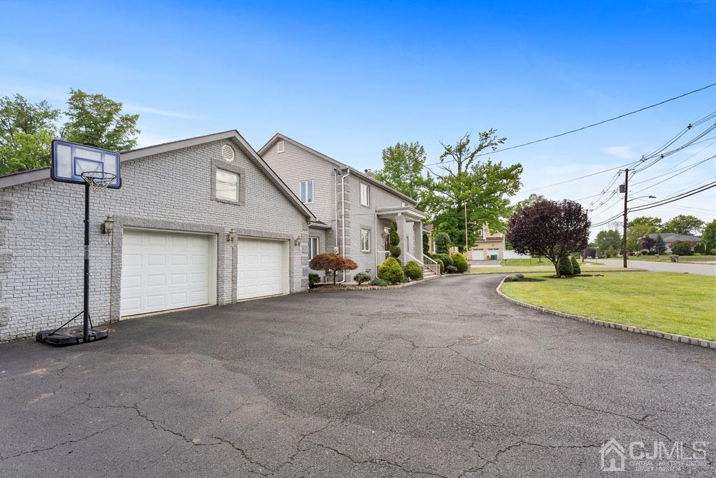 713 New Dover Road Edison, NJ 08820 - Photo 3 of 46 a view of a house with a yard and garage