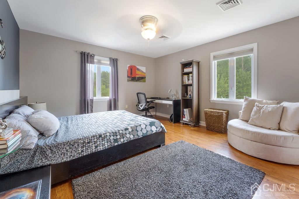 713 New Dover Road Edison, NJ 08820 - Photo 22 of 46 a bedroom with a bed and wooden floor