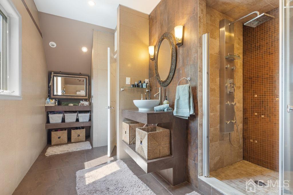 713 New Dover Road Edison, NJ 08820 - Photo 32 of 46 a bathroom with a shower a sink and mirror