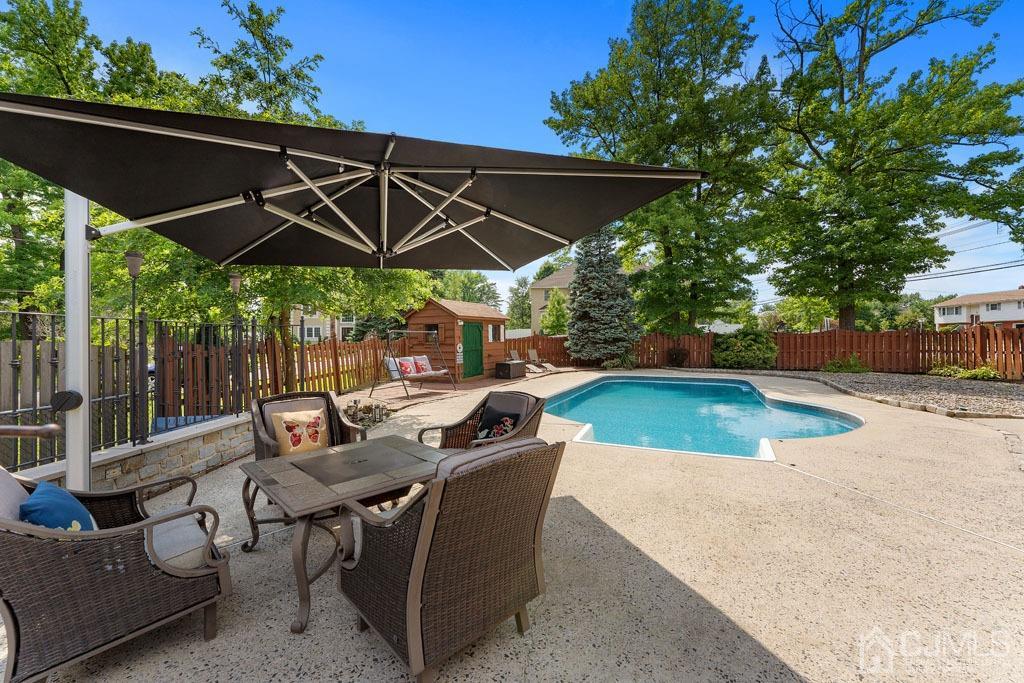 713 New Dover Road Edison, NJ 08820 - Photo 34 of 46 an outdoor space with furniture and umbrella