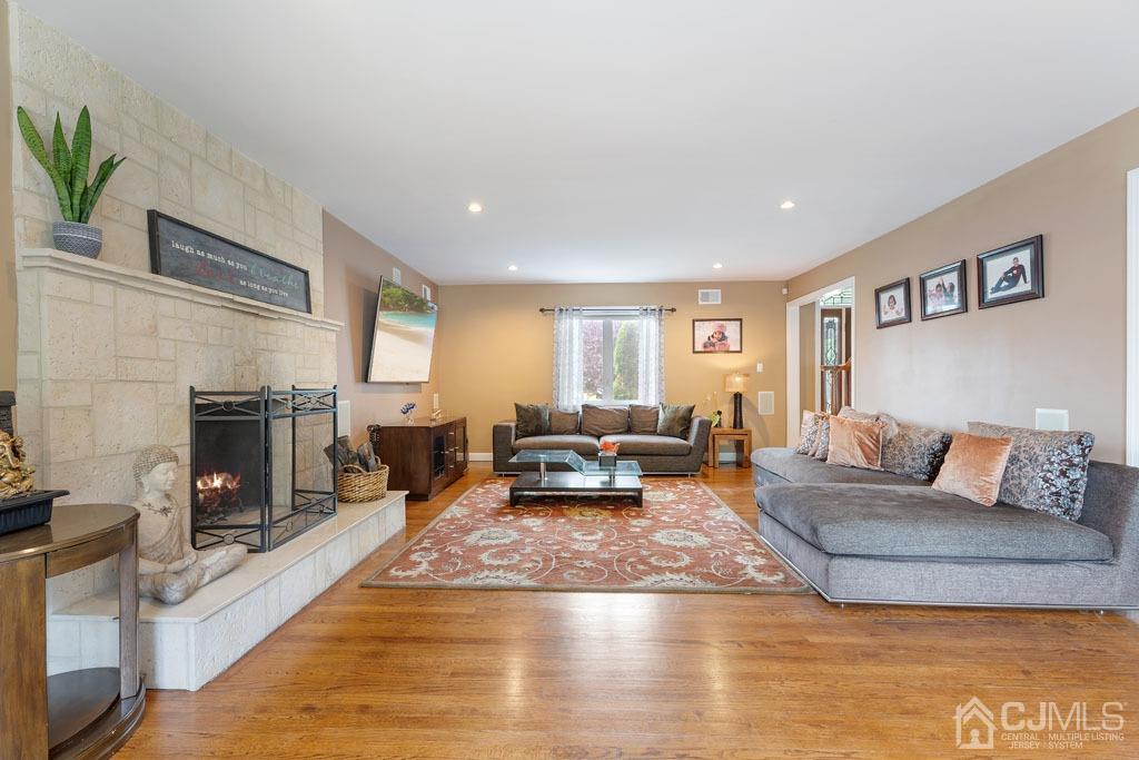 713 New Dover Road Edison, NJ 08820 - Photo 6 of 46 a living room with furniture wooden floor and a fireplace