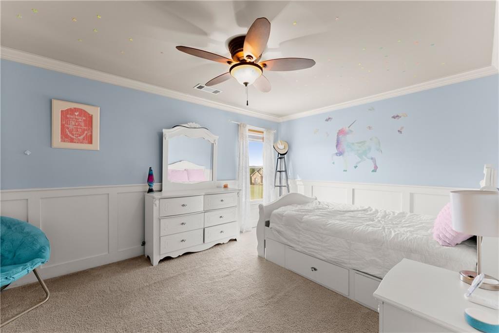 799 Traditions Way Jefferson, GA 30549 - Photo 28 of 53 a bedroom with a bed and a chandelier