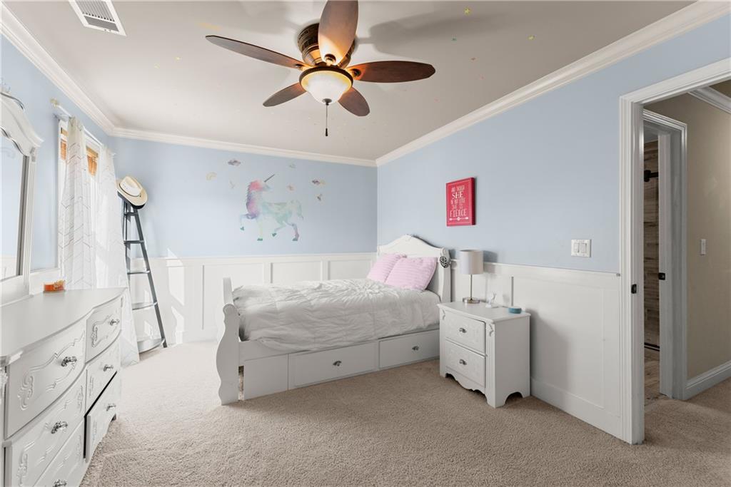 799 Traditions Way Jefferson, GA 30549 - Photo 29 of 53 a bedroom with a bed and a chandelier