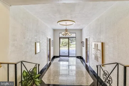 a view of a hallway with furniture and entryway