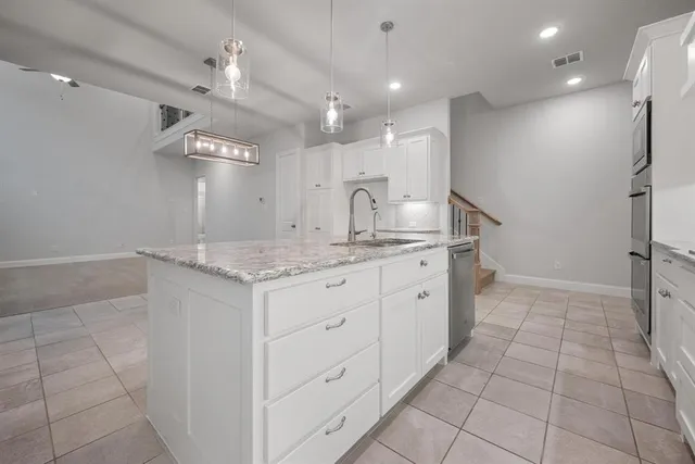 a kitchen with sink and a stove