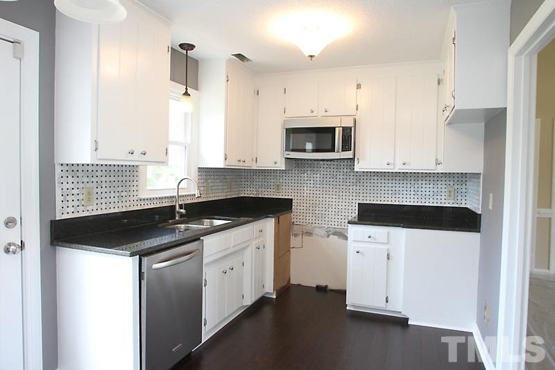 1464 Langdon Road Angier, NC 27501 - Photo 4 of 12 a kitchen with stainless steel appliances granite countertop a sink stove and microwave