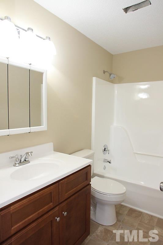 1464 Langdon Road Angier, NC 27501 - Photo 8 of 12 a bathroom with a sink a toilet and shower