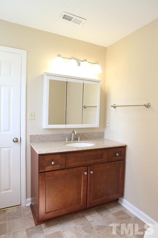 1464 Langdon Road Angier, NC 27501 - Photo 10 of 12 a bathroom with a sink and a mirror
