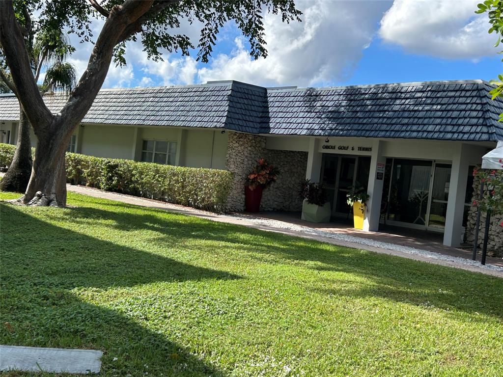 7807 Golf Cir Drive, Unit 205 Margate, FL 33063 - Photo 4 of 5 a front view of a house with a yard