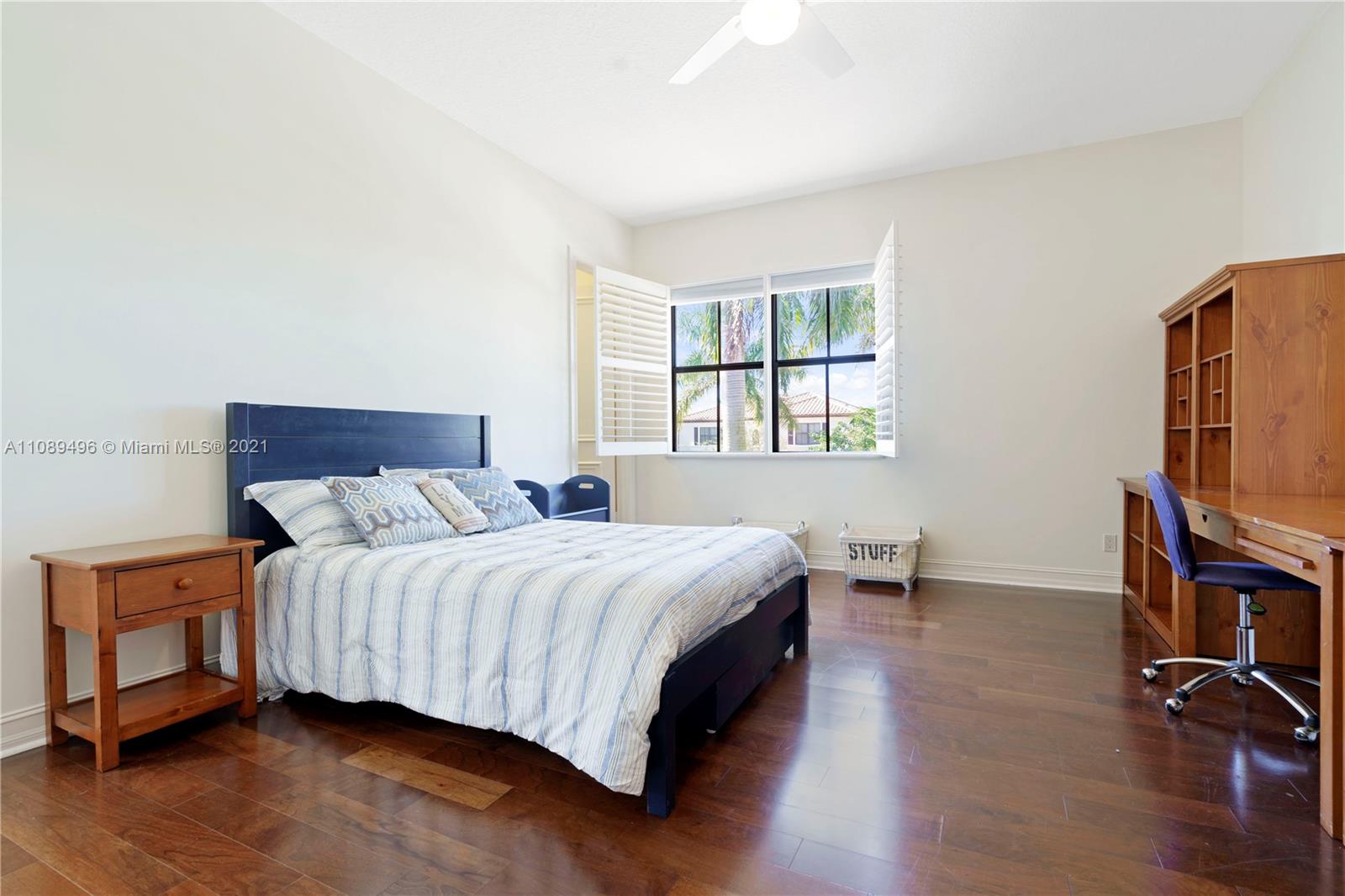 17752 Vecino Way Boca Raton, FL 33496 - Photo 13 of 30 a bedroom with a bed a mirror and a flat tv screen on a dresser