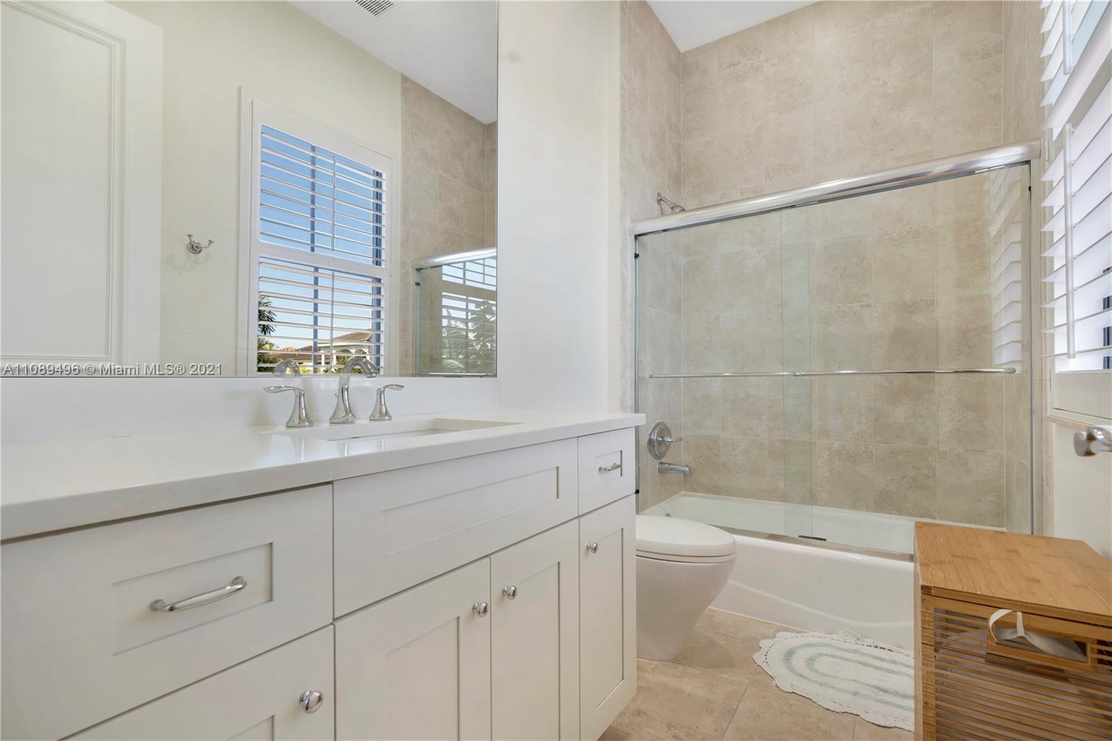 17752 Vecino Way Boca Raton, FL 33496 - Photo 22 of 30 a bathroom with a sink a toilet and shower
