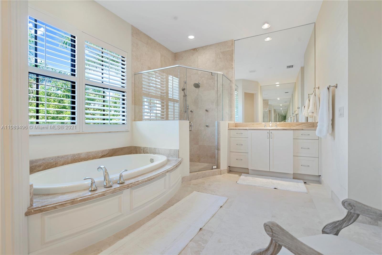 17752 Vecino Way Boca Raton, FL 33496 - Photo 23 of 30 a bathroom with a granite countertop tub sink and mirror