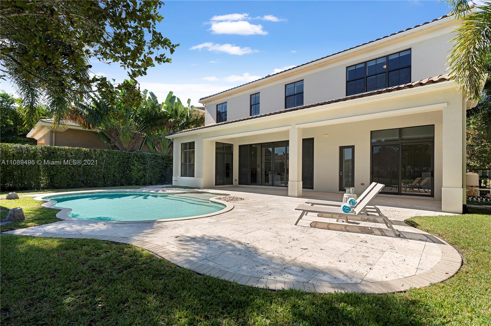 17752 Vecino Way Boca Raton, FL 33496 - Photo 26 of 30 a house view with swimming pool and garden space