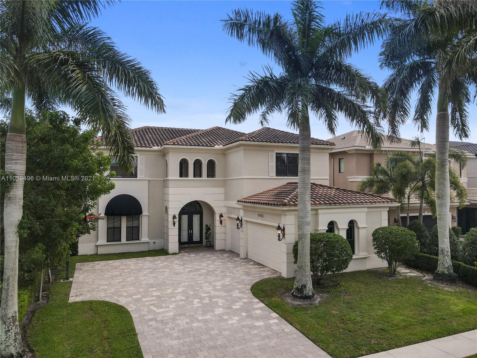 17752 Vecino Way Boca Raton, FL 33496 - Photo 28 of 30 a front view of a house with a yard