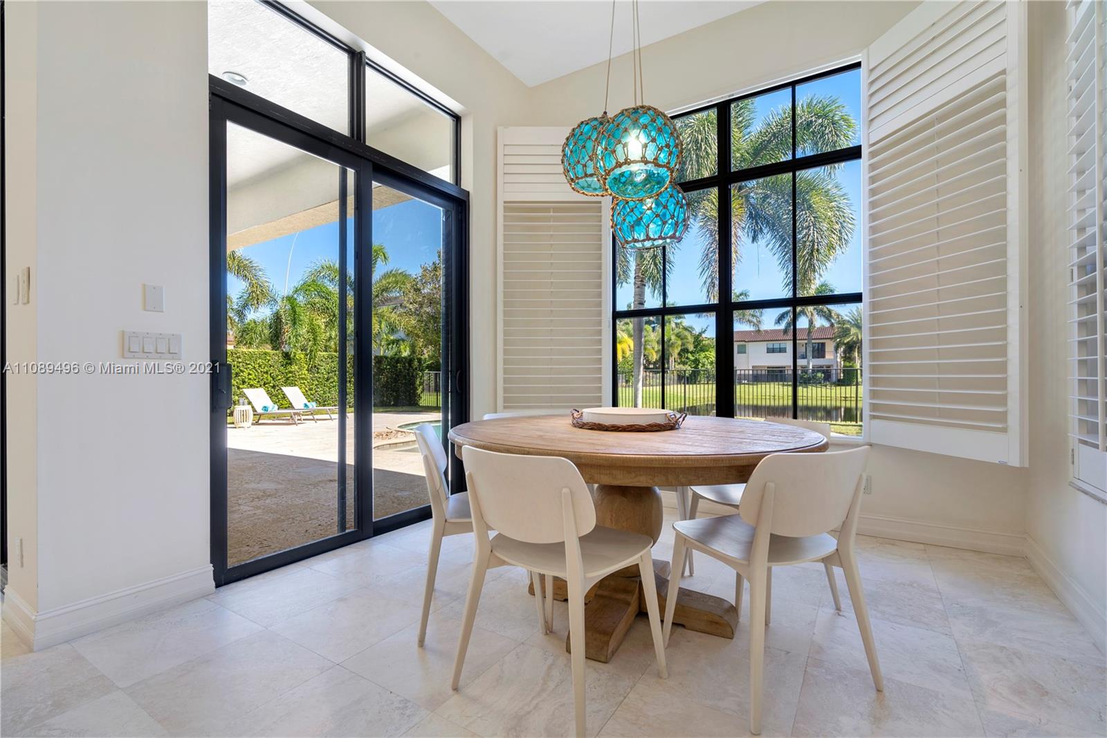 17752 Vecino Way Boca Raton, FL 33496 - Photo 4 of 30 a dining room with furniture and large windows