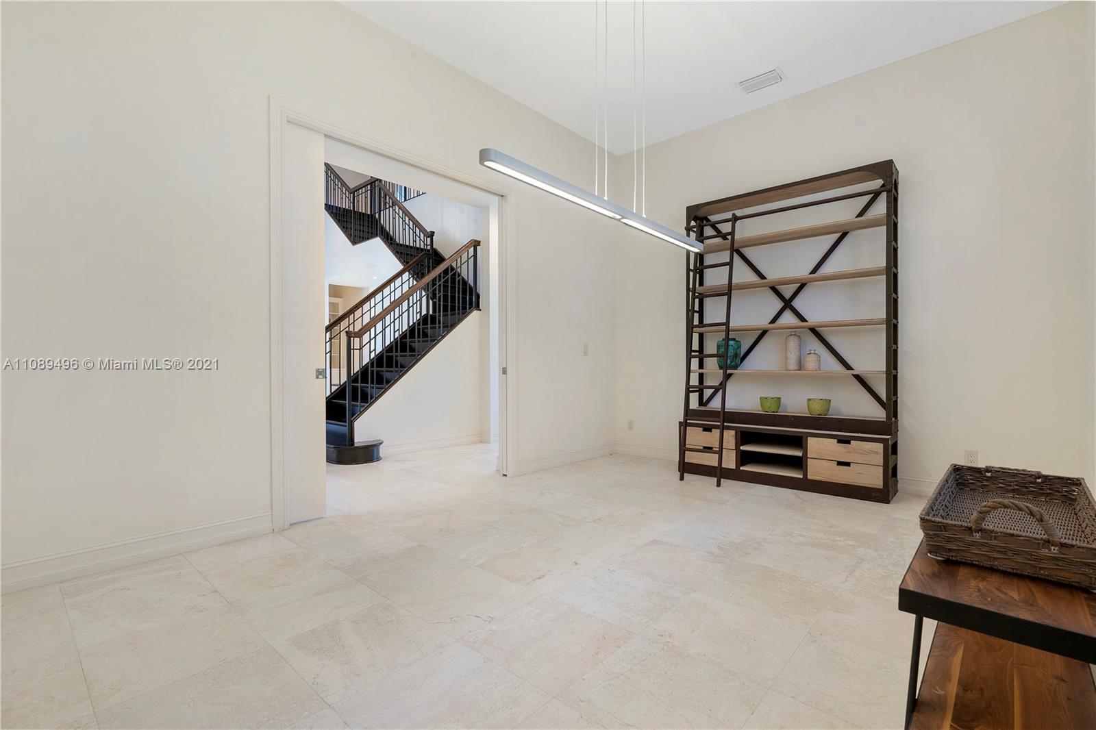 17752 Vecino Way Boca Raton, FL 33496 - Photo 7 of 30 a view of empty room with wooden floor and windows