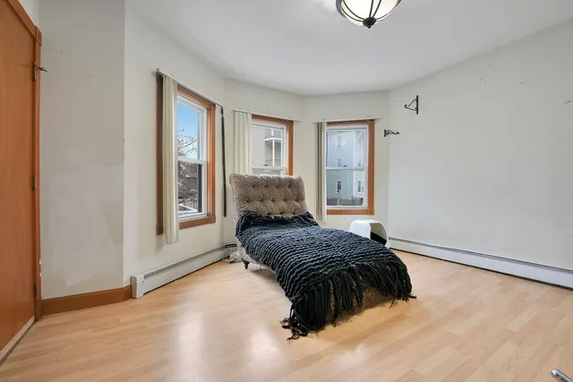 a bedroom with a bed and window