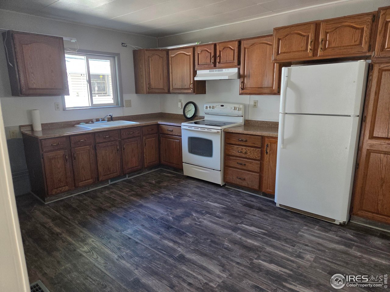 407 Carson Street Brush, CO 80723 - Photo 7 of 38 a kitchen with a refrigerator sink and cabinets