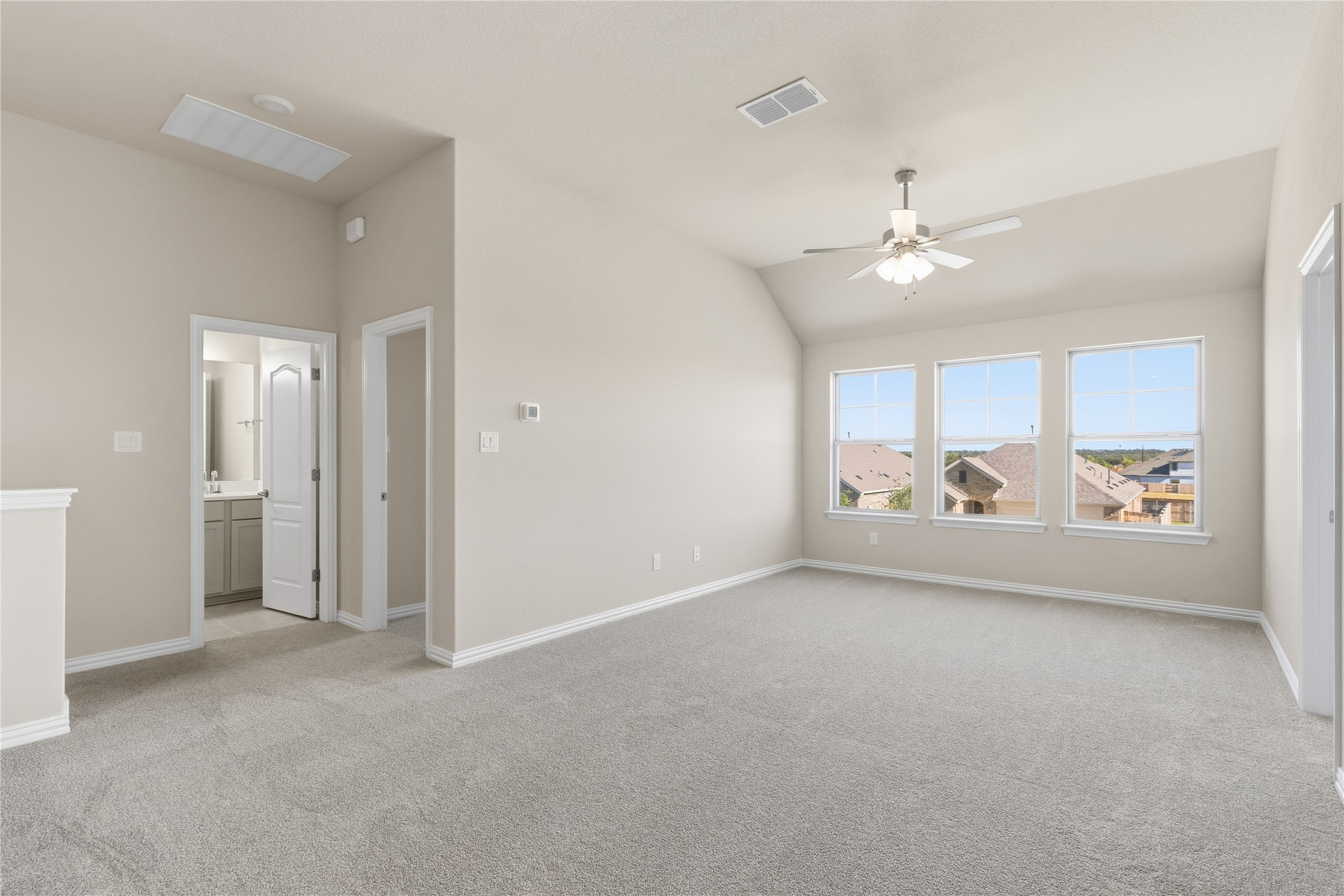 13700 Tucker Hedge Pass Elgin, TX 78621 - Photo 12 of 16 Spare room featuring light carpet, vaulted ceiling, and ceiling fan