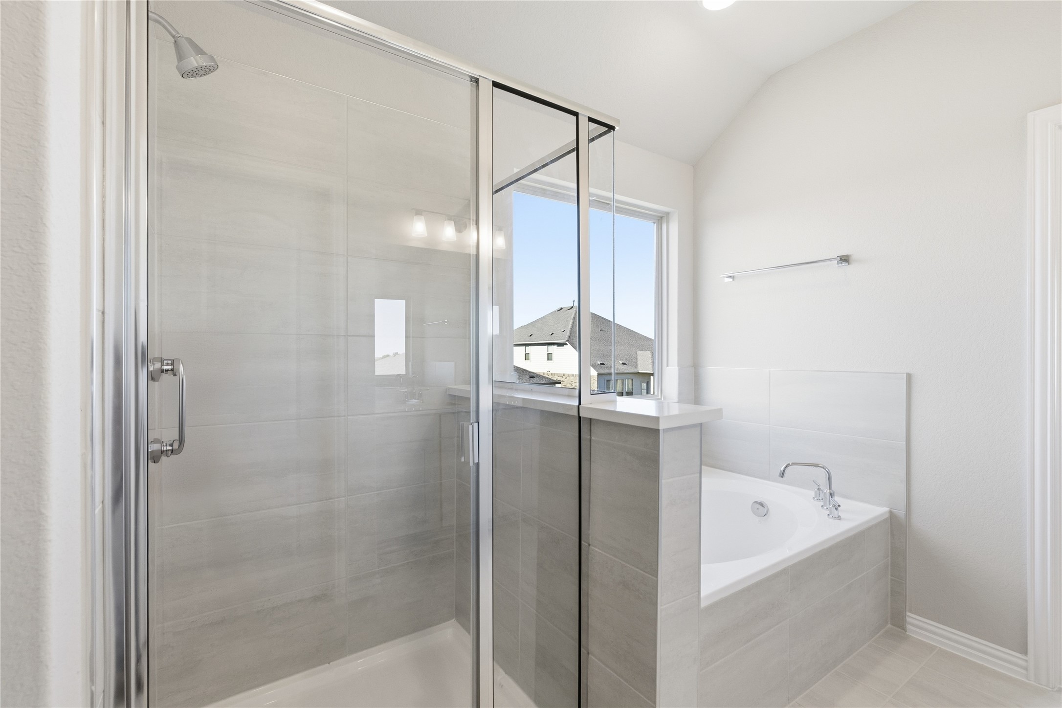 13700 Tucker Hedge Pass Elgin, TX 78621 - Photo 8 of 16 Bathroom featuring a stall shower, a bath, light tile patterned floors, and vaulted ceiling