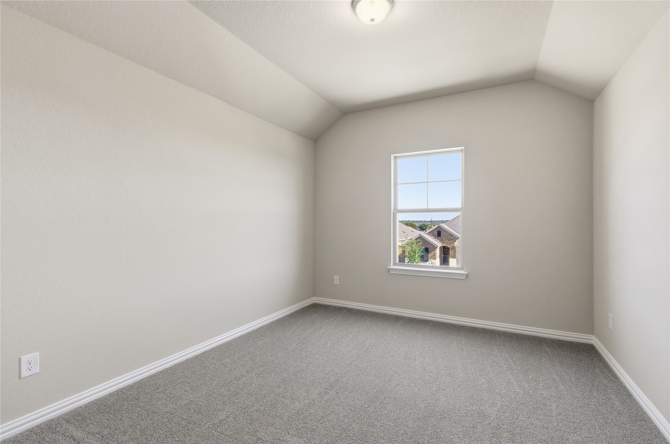 13700 Tucker Hedge Pass Elgin, TX 78621 - Photo 10 of 16 Carpeted empty room with lofted ceiling and baseboards