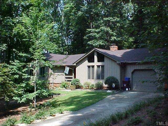 9720 Rock Creek Road Raleigh, NC 27613 - Photo 1 of 1 a front view of a house with a yard and garage