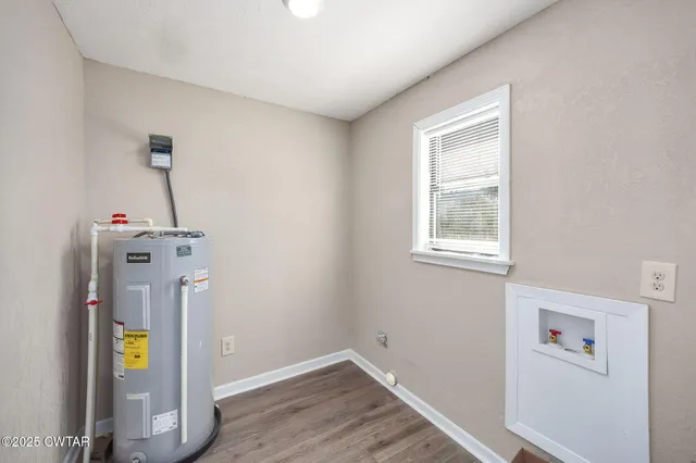 a view of an empty room with wooden walls