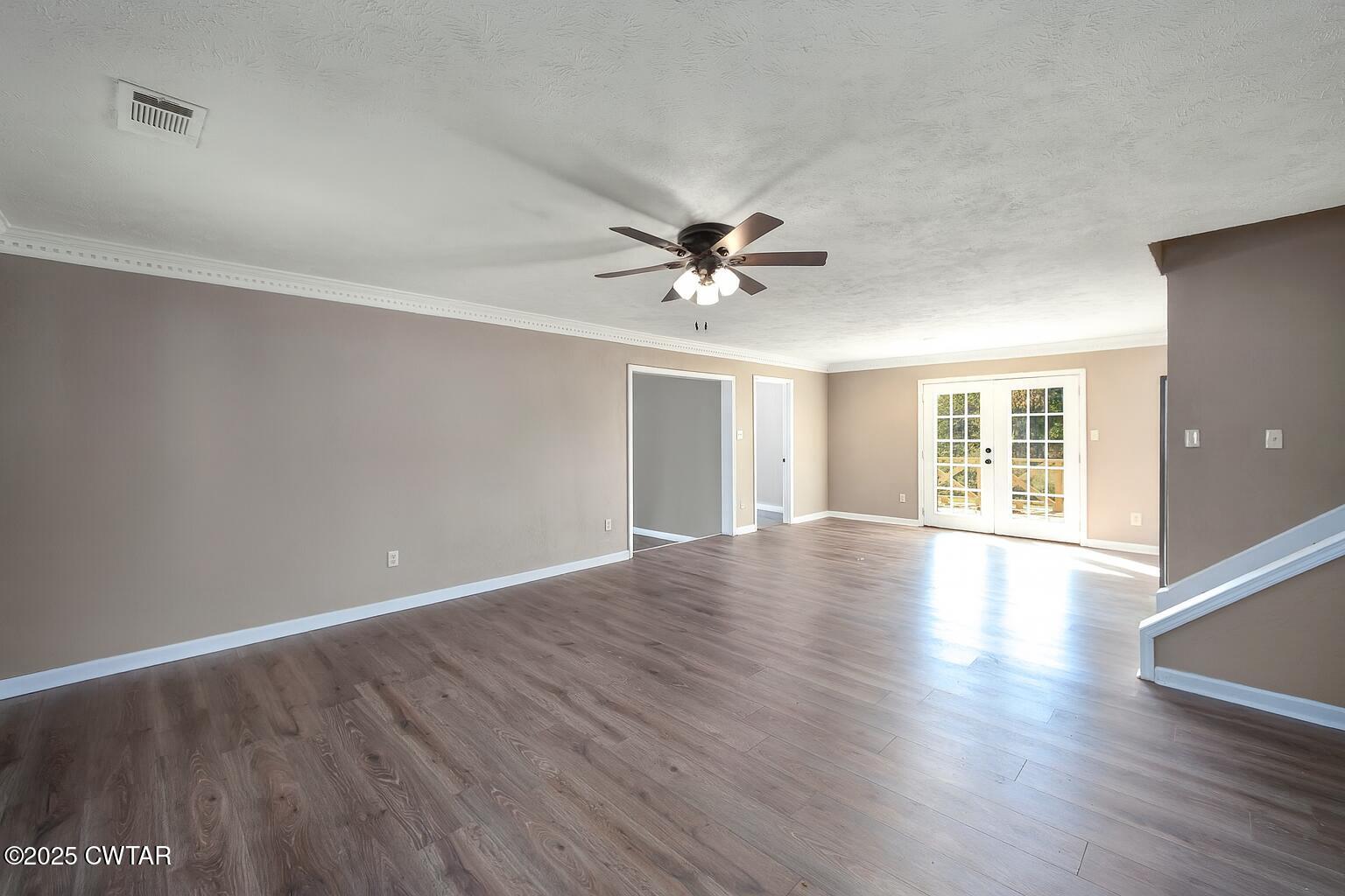 4135 Eurekaton Road Stanton, TN 38069 - Photo 2 of 33 a view of an empty room with wooden floor and a window