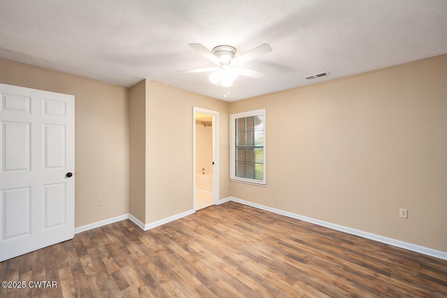 4135 Eurekaton Road Stanton, TN 38069 - Photo 6 of 33 a view of empty room with wooden floor and fan