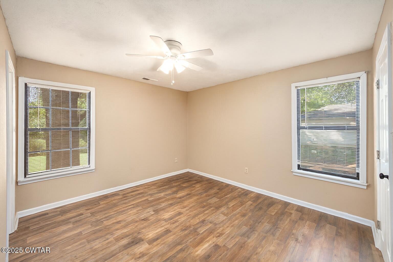 4135 Eurekaton Road Stanton, TN 38069 - Photo 8 of 33 wooden floor in an empty room with a window