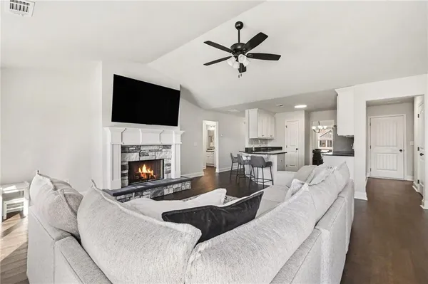 a living room with furniture a fireplace and a flat screen tv