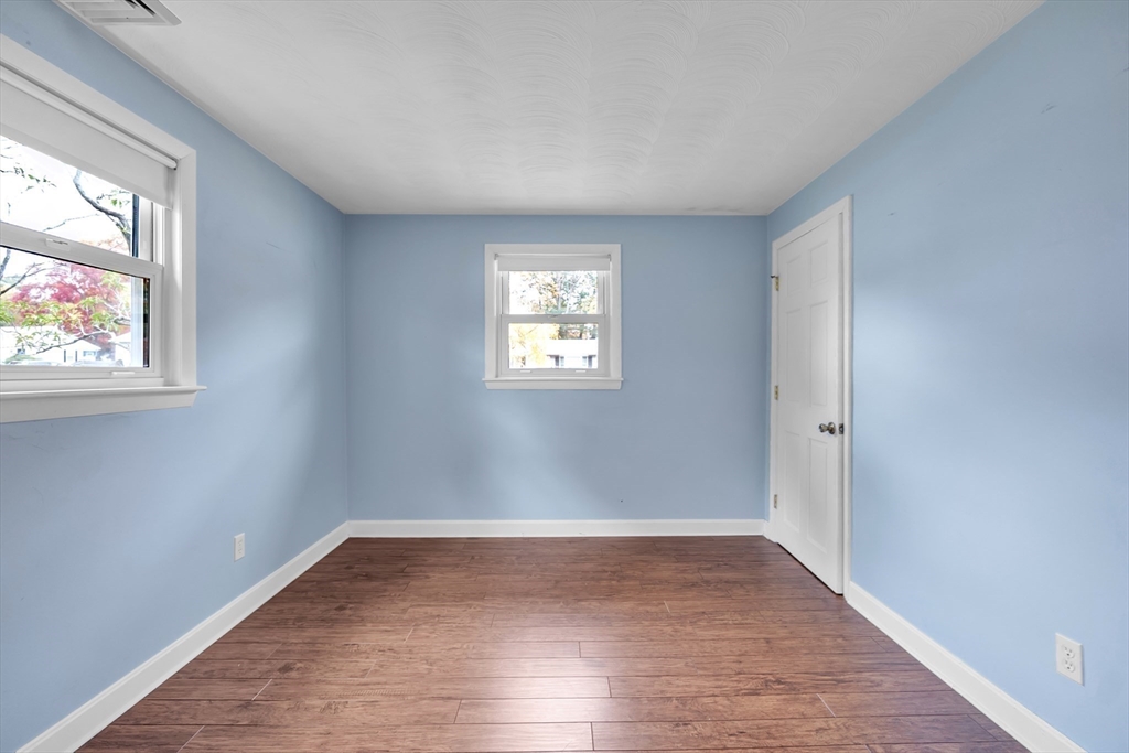15 Fairbrook Road Framingham, MA 01701 - Photo 21 of 28 an empty room with wooden floor and windows