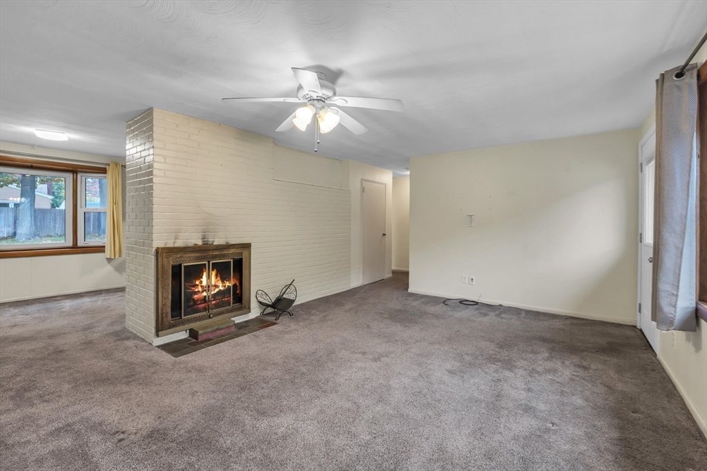 15 Fairbrook Road Framingham, MA 01701 - Photo 5 of 28 an empty room with windows and fireplace