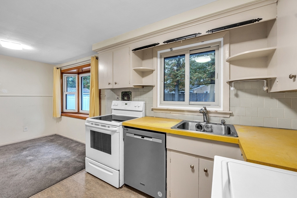 15 Fairbrook Road Framingham, MA 01701 - Photo 9 of 28 a kitchen with a stove a sink and a refrigerator