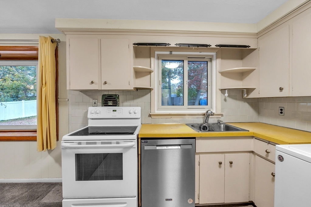 15 Fairbrook Road Framingham, MA 01701 - Photo 10 of 28 a kitchen with a sink stove and cabinets