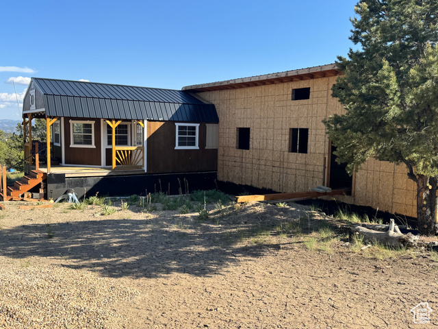 46205 Little Elk Road Fruitland, UT 84027 - Photo 4 of 24 View of front facade with metal roof, a gambrel roof, and covered porch
