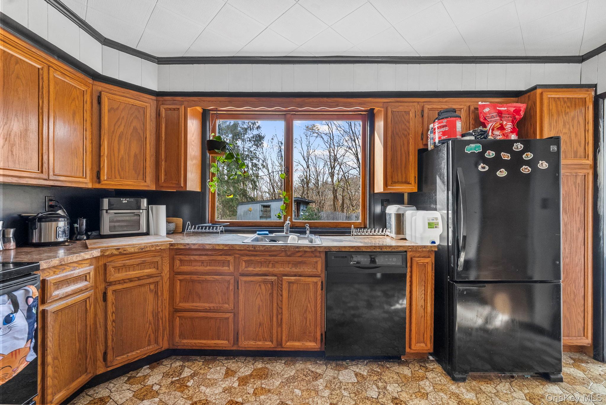 45 Baker Road Hopewell Junction, NY 12533 - Photo 16 of 41 a kitchen with kitchen island granite countertop a refrigerator and a sink