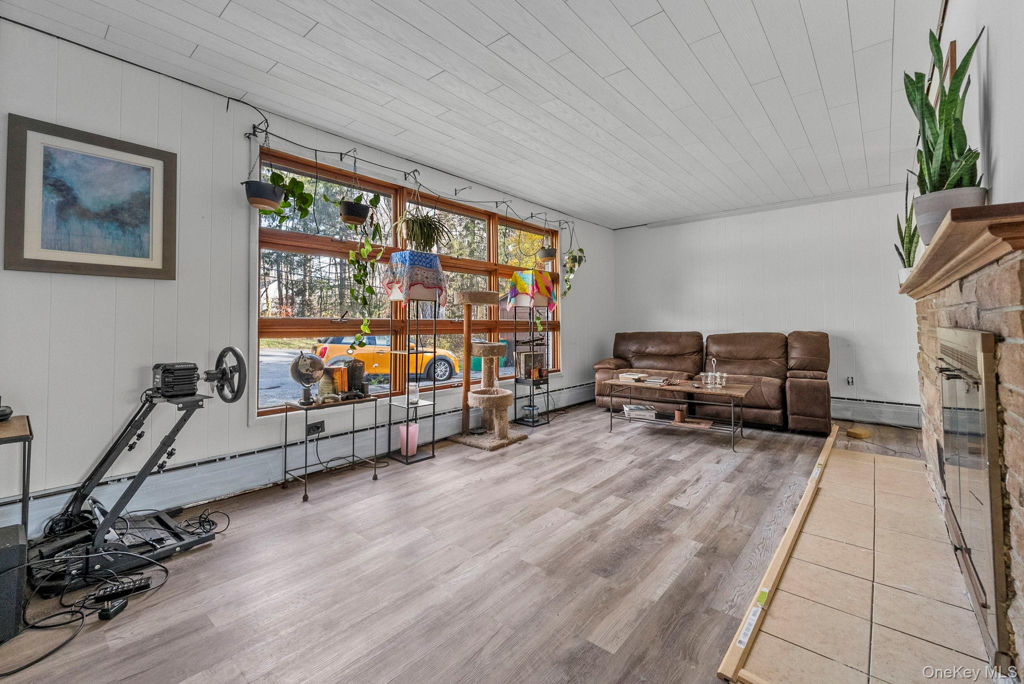 45 Baker Road Hopewell Junction, NY 12533 - Photo 20 of 41 a living room with furniture gym equipment and a flat screen tv