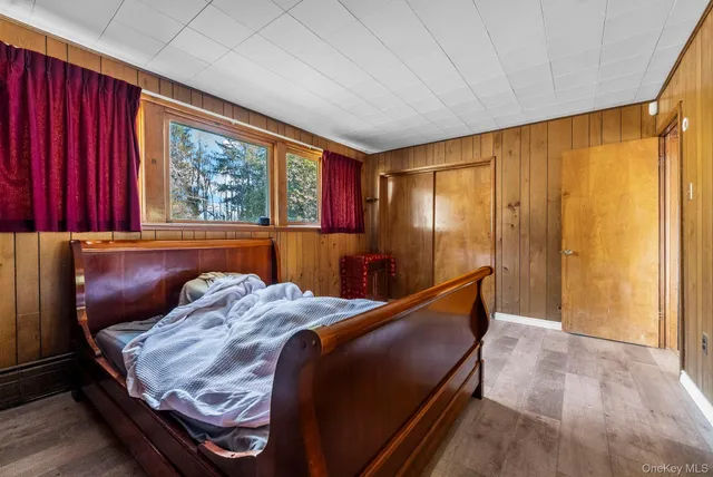 a bed sitting in a bedroom next to a window