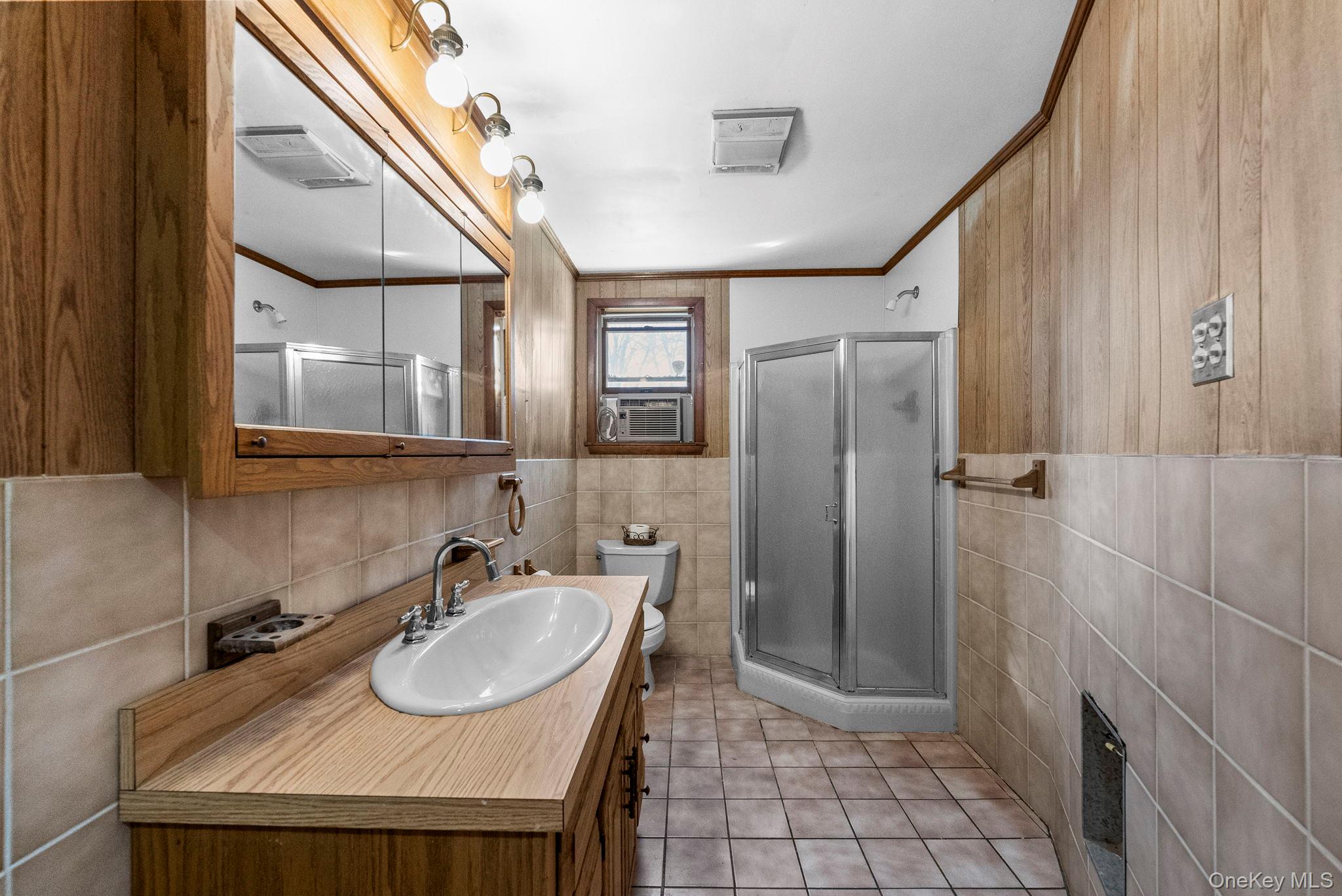45 Baker Road Hopewell Junction, NY 12533 - Photo 29 of 41 a bathroom with a sink a mirror and a shower