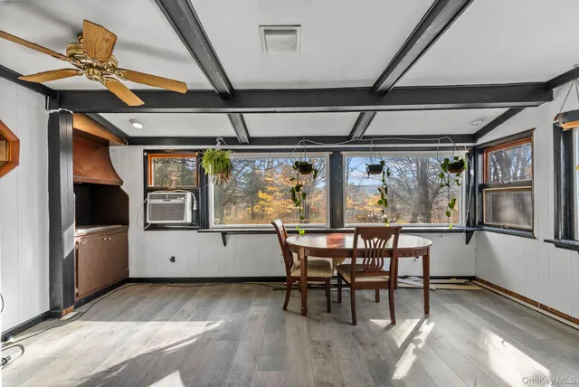 a view of a dining room with furniture window and wooden floor