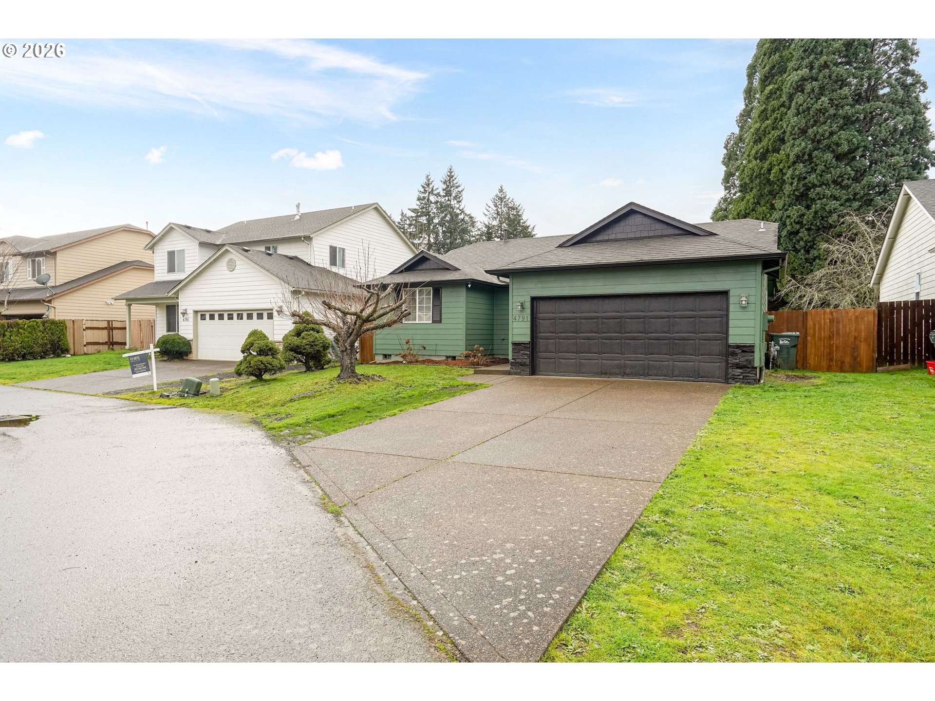 4791 Currant Lane Northeast Salem, OR 97305 - Photo 2 of 42 a front view of a house with a yard and garage