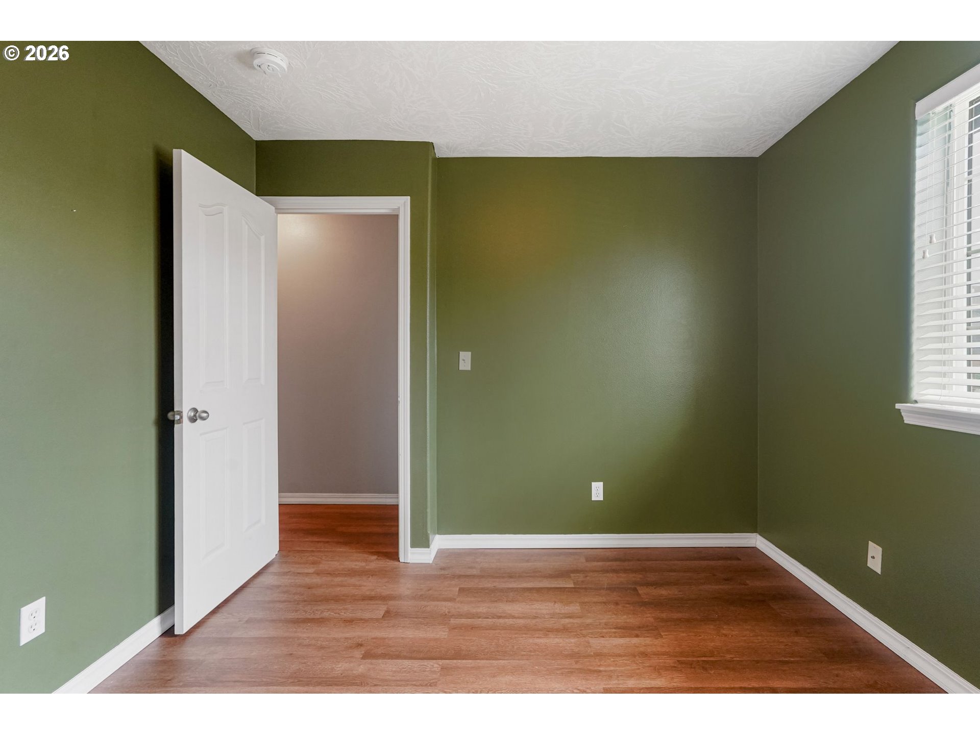 4791 Currant Lane Northeast Salem, OR 97305 - Photo 34 of 42 a view of an empty room with wooden floor and a window