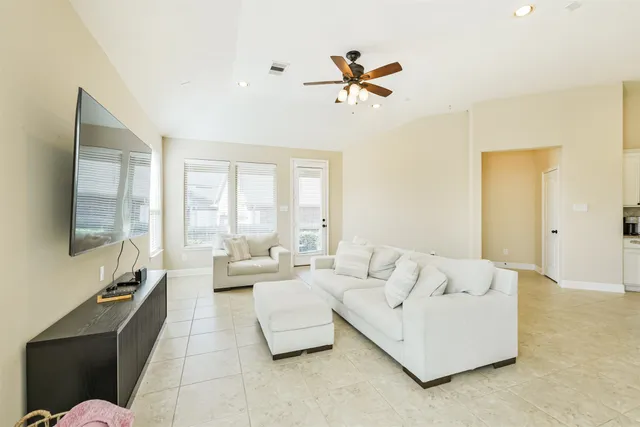 a living room with fireplace furniture and a flat screen tv