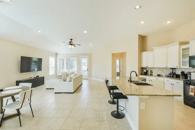 a kitchen with sink refrigerator and cabinets