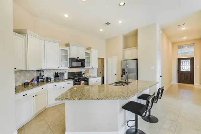 a kitchen with a sink stove and cabinets