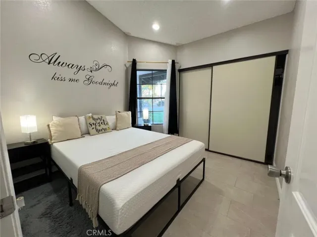 a bedroom with a bed and a mirror